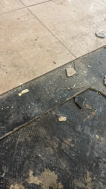 Black bitumen mastic floor removal in a W1 flat